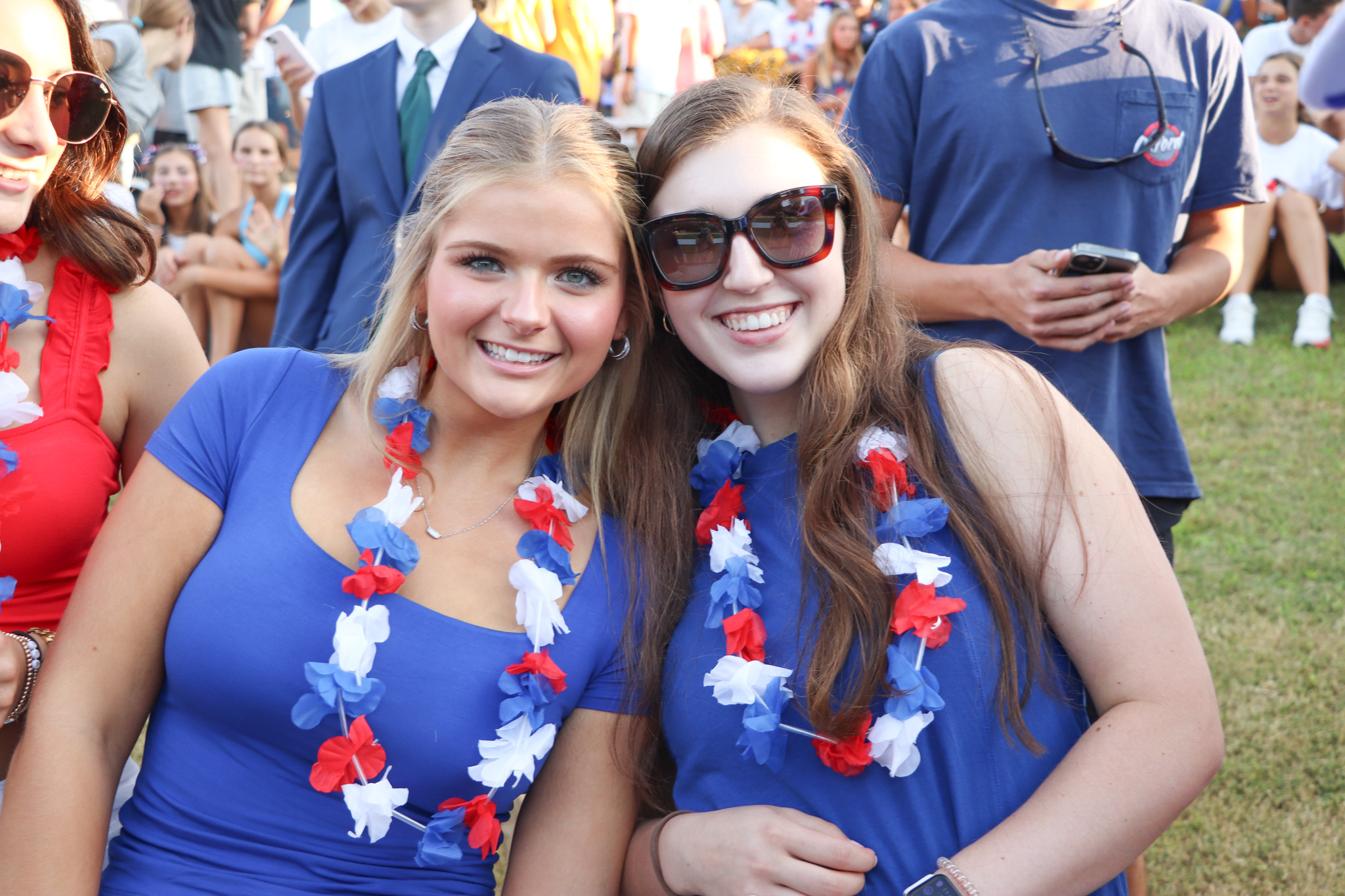 two students posing together at an outdoor event